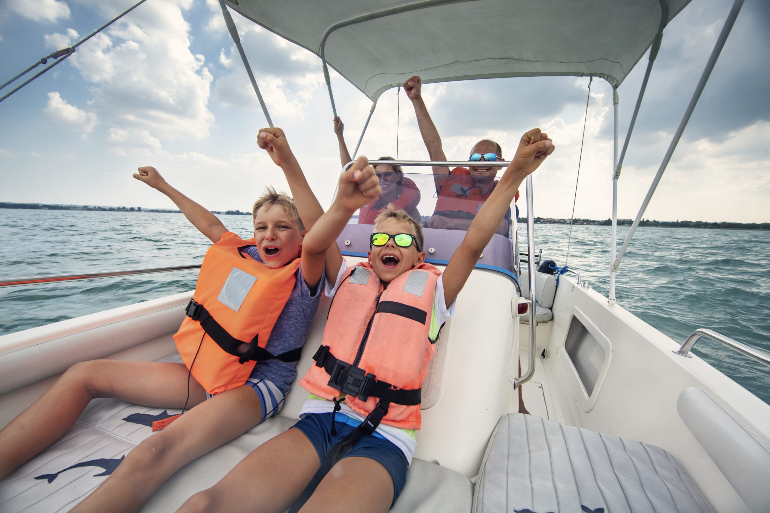 Family enjoying riding a boat on Lake Garda